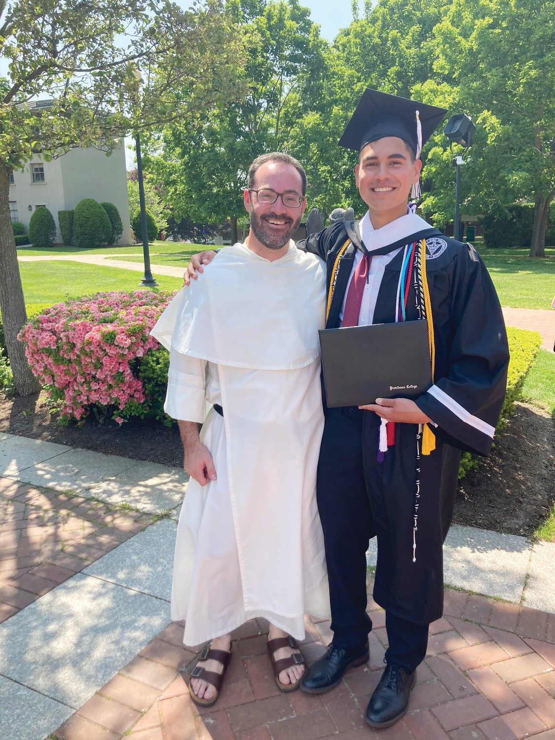 Trevor Wakefield stands with one of his Dominican mentors, Father Michael Weibley, O.P., at his Providence College commencement in 2021.
